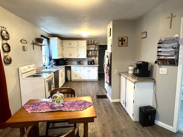 109 Rocket Dr, Badger, MN 56714 - kitchen featuring white range with electric stovetop, dark wood-type flooring, light countertops, white cabinetry, and dishwashing machine