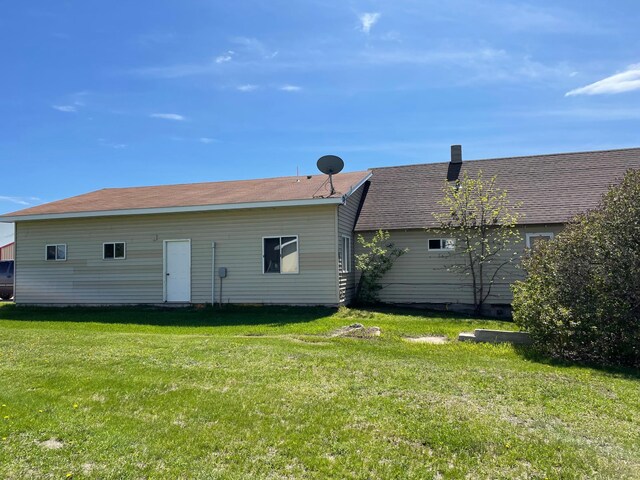 109 Rocket Dr, Badger, MN 56714 - rear view of property featuring a lawn