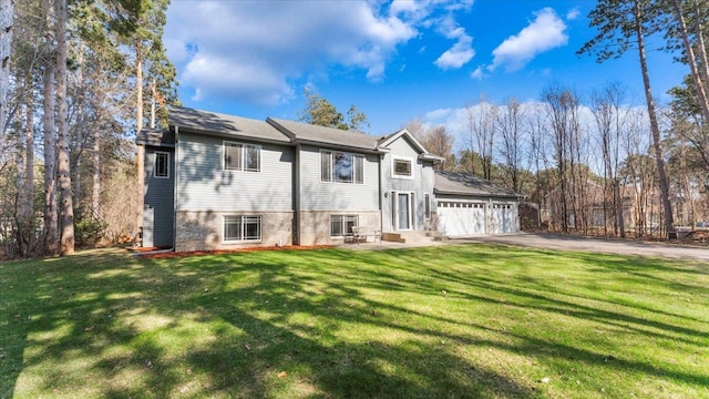 9112 Indigo Rd NW, Watab Twp, MN 56367 - rear view of property with a lawn and aphalt driveway