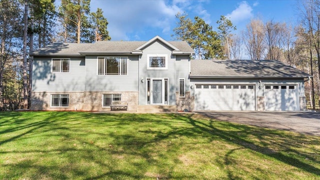 9112 Indigo Rd NW, Watab Twp, MN 56367 - tri-level home featuring an attached garage, aphalt driveway, and a front lawn