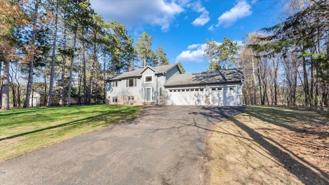 9112 Indigo Rd NW, Watab Twp, MN 56367 - view of front facade featuring an attached garage, aphalt driveway, and a front yard
