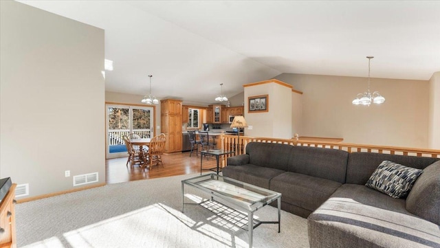 9112 Indigo Rd NW, Watab Twp, MN 56367 - living area featuring light colored carpet, vaulted ceiling, a chandelier, and visible vents