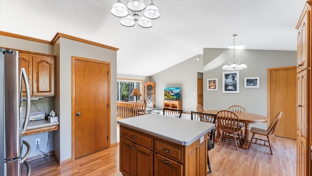9112 Indigo Rd NW, Watab Twp, MN 56367 - kitchen featuring light countertops, vaulted ceiling, freestanding refrigerator, light wood-style flooring, and a notable chandelier