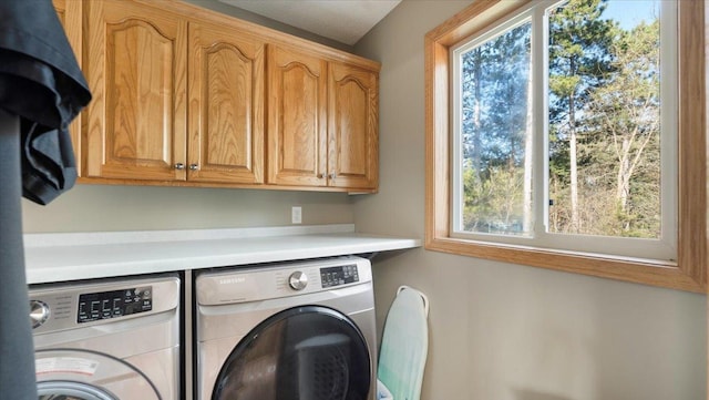 9112 Indigo Rd NW, Watab Twp, MN 56367 - washroom featuring cabinet space, a wealth of natural light, and washer and clothes dryer