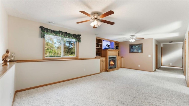 9112 Indigo Rd NW, Watab Twp, MN 56367 - unfurnished living room featuring a lit fireplace, light carpet, baseboards, and ceiling fan