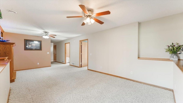 9112 Indigo Rd NW, Watab Twp, MN 56367 - unfurnished living room with baseboards, light colored carpet, and ceiling fan