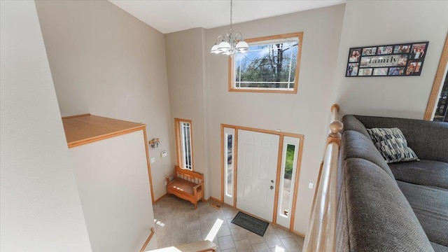 9112 Indigo Rd NW, Watab Twp, MN 56367 - entrance foyer with a high ceiling, baseboards, a notable chandelier, and light tile patterned floors