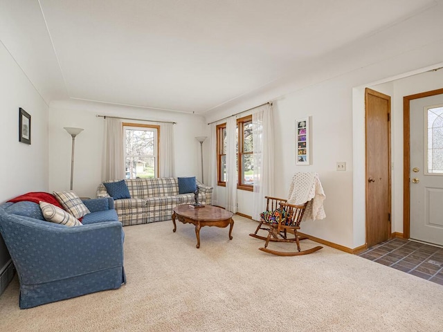 carpeted living room featuring baseboards