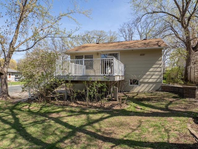 back of property featuring a yard, stairway, a wooden deck, and fence