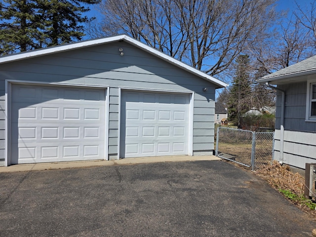 detached garage featuring fence