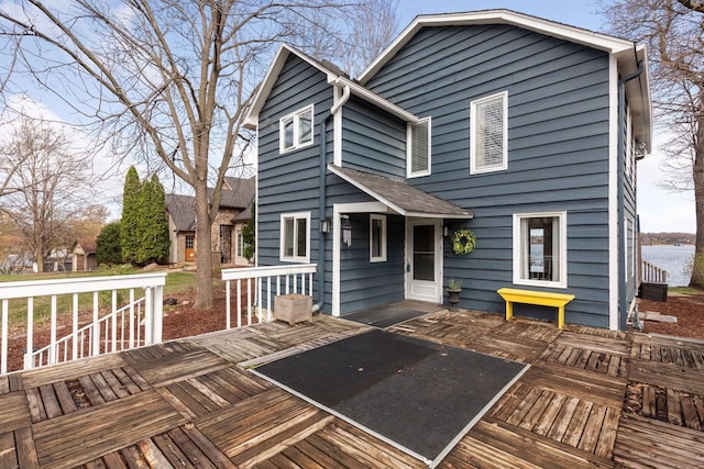 back of house featuring a deck with water view