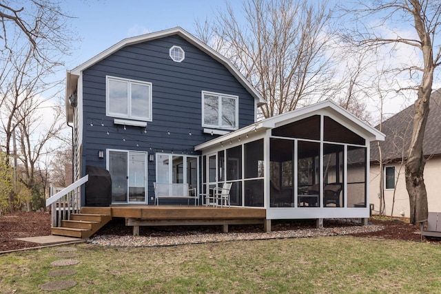rear view of house with a sunroom and a yard