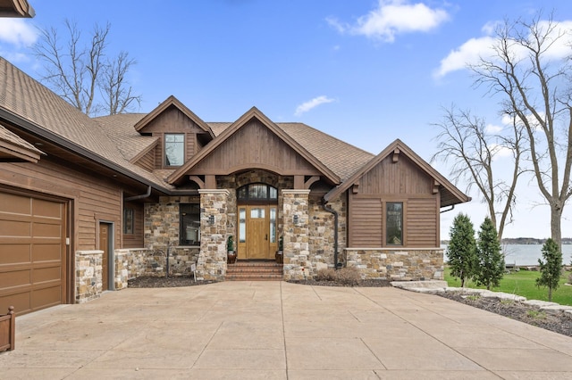 623 Shore Dr, Forest Lake, MN 55025 - craftsman house with a garage, a shingled roof, and stone siding