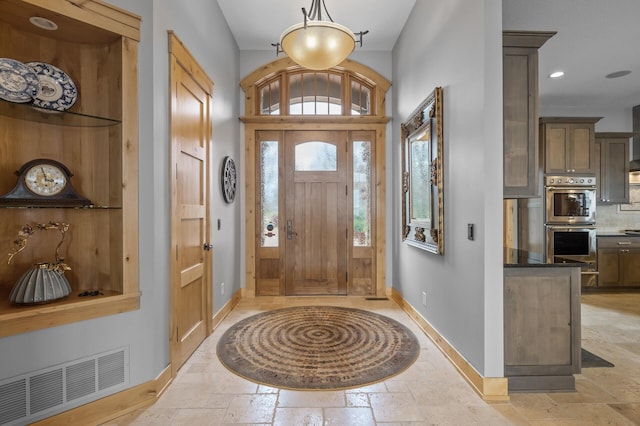 623 Shore Dr, Forest Lake, MN 55025 - foyer featuring baseboards, visible vents, and stone tile floors