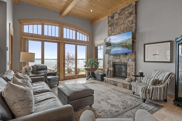 623 Shore Dr, Forest Lake, MN 55025 - living room featuring beam ceiling, a fireplace, stone tile floors, a towering ceiling, and wood ceiling