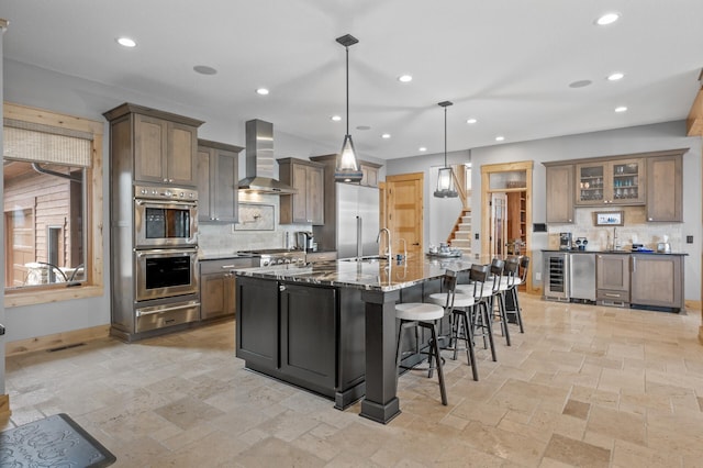 623 Shore Dr, Forest Lake, MN 55025 - kitchen featuring wall chimney range hood, appliances with stainless steel finishes, tasteful backsplash, a warming drawer, and recessed lighting