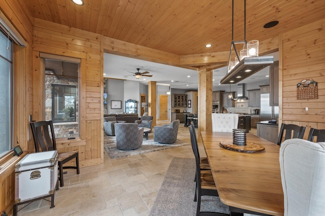 623 Shore Dr, Forest Lake, MN 55025 - dining area with recessed lighting, wood walls, and stone tile floors