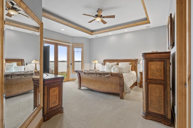 623 Shore Dr, Forest Lake, MN 55025 - bedroom with light carpet, access to outside, recessed lighting, a raised ceiling, and a water view