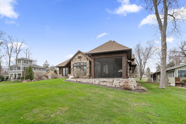 623 Shore Dr, Forest Lake, MN 55025 - back of house with a shingled roof, a yard, and stone siding