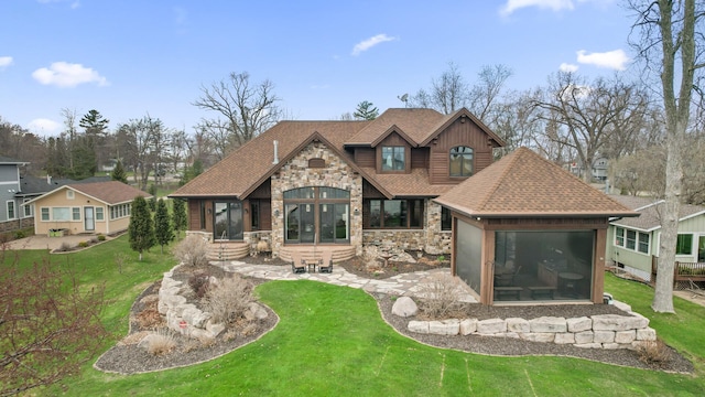 623 Shore Dr, Forest Lake, MN 55025 - back of house featuring a yard, roof with shingles, and stone siding