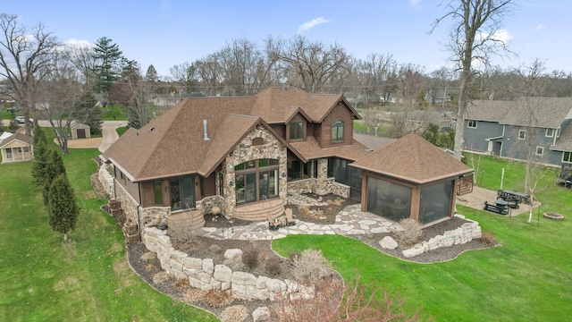 623 Shore Dr, Forest Lake, MN 55025 - back of house featuring a yard, a shingled roof, and stone siding