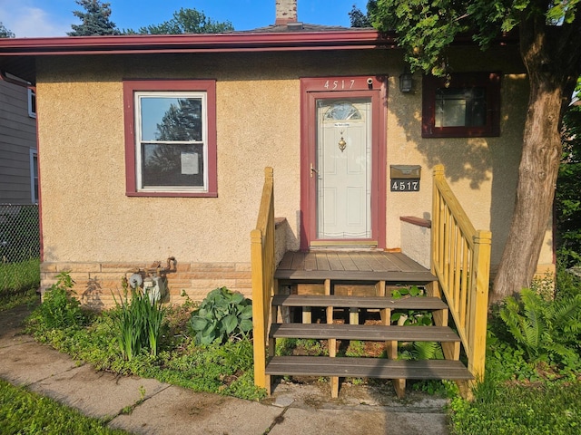 4517 4th Ave S, Minneapolis, MN 55419 - doorway to property featuring stucco siding and a chimney
