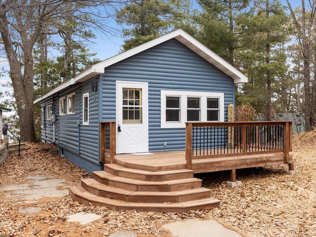 18670 483rd St, Shamrock Twp, MN 55760 - rear view of property with faux log siding and a wooden deck