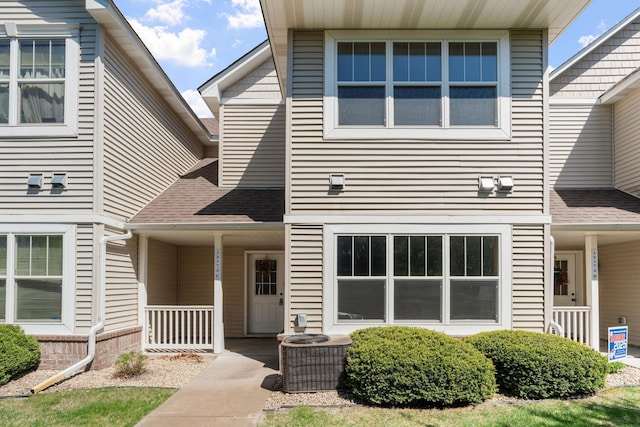 12172 Waconia St NE Unit C, Blaine, MN 55449 - view of front facade featuring covered porch, central air condition unit, and roof with shingles