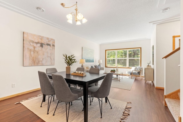 12172 Waconia St NE Unit C, Blaine, MN 55449 - dining area with a chandelier, stairway, wood finished floors, a textured ceiling, and baseboards