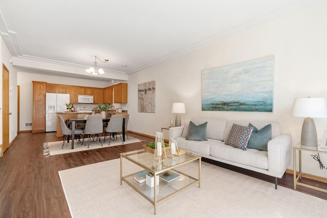 12172 Waconia St NE Unit C, Blaine, MN 55449 - living room with a chandelier, wood finished floors, baseboards, and crown molding