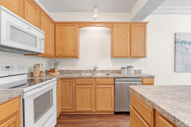 12172 Waconia St NE Unit C, Blaine, MN 55449 - kitchen featuring white appliances, a sink, wood finished floors, light countertops, and light brown cabinetry