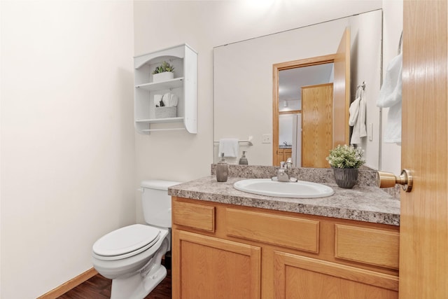 12172 Waconia St NE Unit C, Blaine, MN 55449 - half bathroom featuring toilet, vanity, and wood finished floors