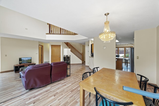10695 53rd Ave N, Plymouth, MN 55442 - dining space featuring a chandelier, light wood finished floors, and stairs