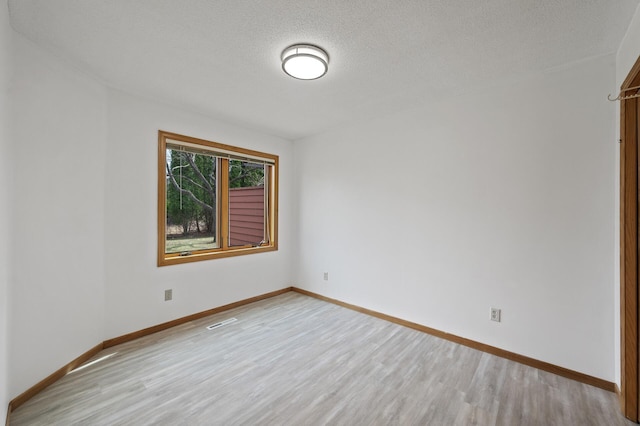 10695 53rd Ave N, Plymouth, MN 55442 - empty room with light wood-type flooring, baseboards, and a textured ceiling