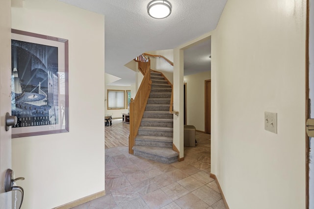 10695 53rd Ave N, Plymouth, MN 55442 - foyer with stairway, baseboards, and a textured ceiling