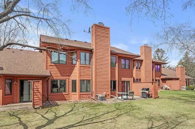 10695 53rd Ave N, Plymouth, MN 55442 - back of property with a chimney, a yard, roof with shingles, and central AC