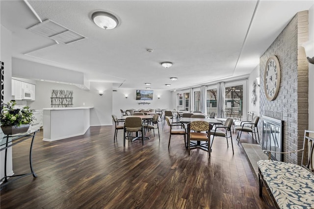 10411 Cedar Lake Rd Unit 301, Minnetonka, MN 55305 - dining area featuring dark wood-type flooring, a fireplace, and visible vents