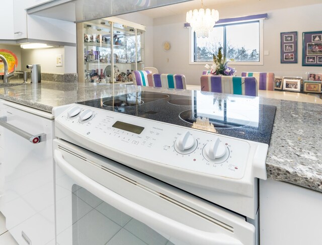 10411 Cedar Lake Rd Unit 301, Minnetonka, MN 55305 - kitchen with a sink, a notable chandelier, white cabinetry, and electric stove