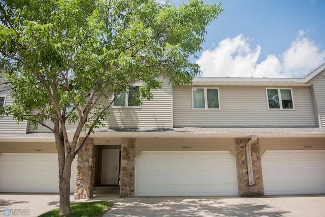 3220 40th Ave S Unit D, Fargo, ND 58104 - townhome / multi-family property featuring a garage, driveway, and stone siding