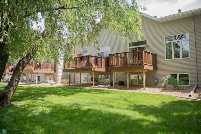 3220 40th Ave S Unit D, Fargo, ND 58104 - rear view of house featuring a yard, a wooden deck, and central AC unit