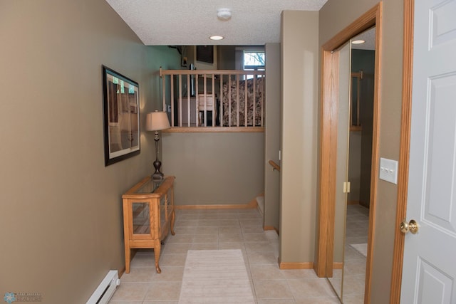 3220 40th Ave S Unit D, Fargo, ND 58104 - corridor with a textured ceiling, tile patterned flooring, stairs, a baseboard radiator, and baseboards