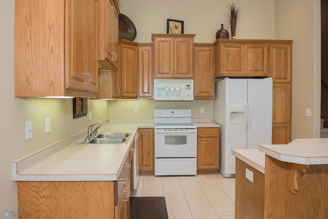 3220 40th Ave S Unit D, Fargo, ND 58104 - kitchen featuring light tile patterned floors, a sink, light countertops, white appliances, and brown cabinetry