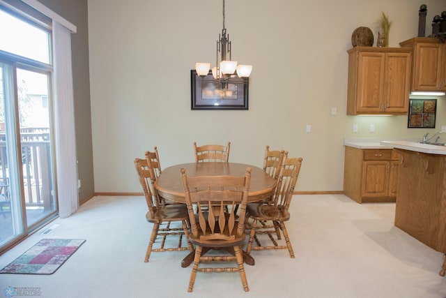 3220 40th Ave S Unit D, Fargo, ND 58104 - dining room featuring a chandelier, baseboards, plenty of natural light, and light colored carpet