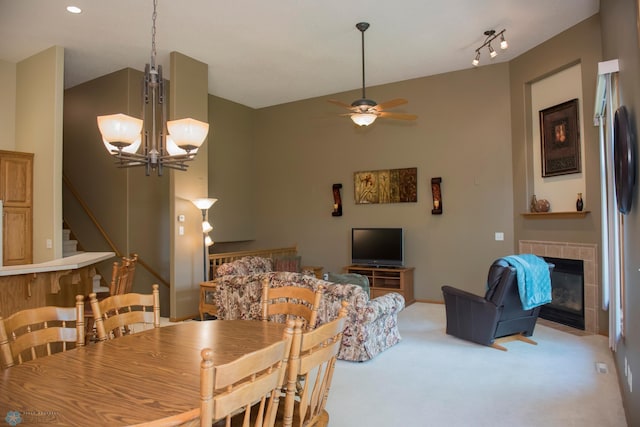 3220 40th Ave S Unit D, Fargo, ND 58104 - carpeted dining room featuring stairway, lofted ceiling, a tile fireplace, and ceiling fan with notable chandelier