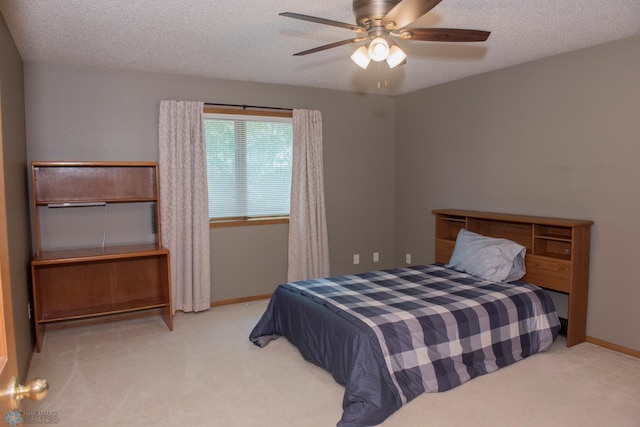 3220 40th Ave S Unit D, Fargo, ND 58104 - bedroom featuring a textured ceiling, carpet flooring, baseboards, and a ceiling fan