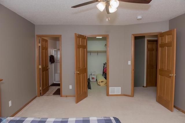 3220 40th Ave S Unit D, Fargo, ND 58104 - bedroom with visible vents, a spacious closet, light carpet, and a textured ceiling