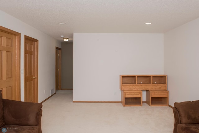 3220 40th Ave S Unit D, Fargo, ND 58104 - sitting room with light carpet, recessed lighting, baseboards, and a textured ceiling