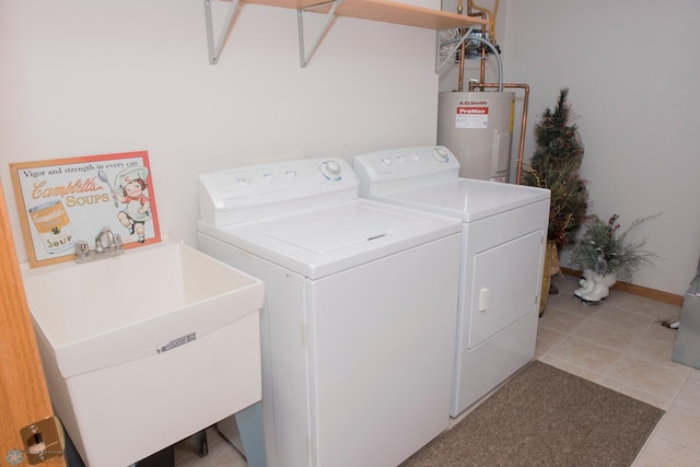 3220 40th Ave S Unit D, Fargo, ND 58104 - clothes washing area featuring electric water heater, separate washer and dryer, light tile patterned floors, laundry area, and a sink