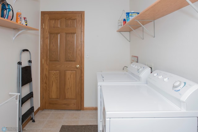 3220 40th Ave S Unit D, Fargo, ND 58104 - washroom featuring laundry area, light tile patterned floors, baseboards, and washer and clothes dryer