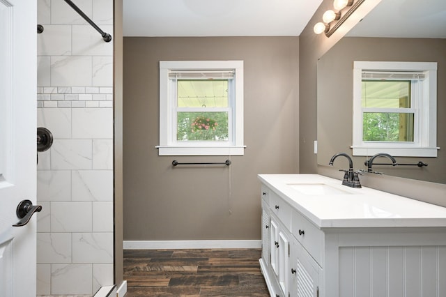 24182 184th St NW, Orrock Twp, MN 55309 - bathroom featuring wood finished floors, vanity, a tile shower, and baseboards